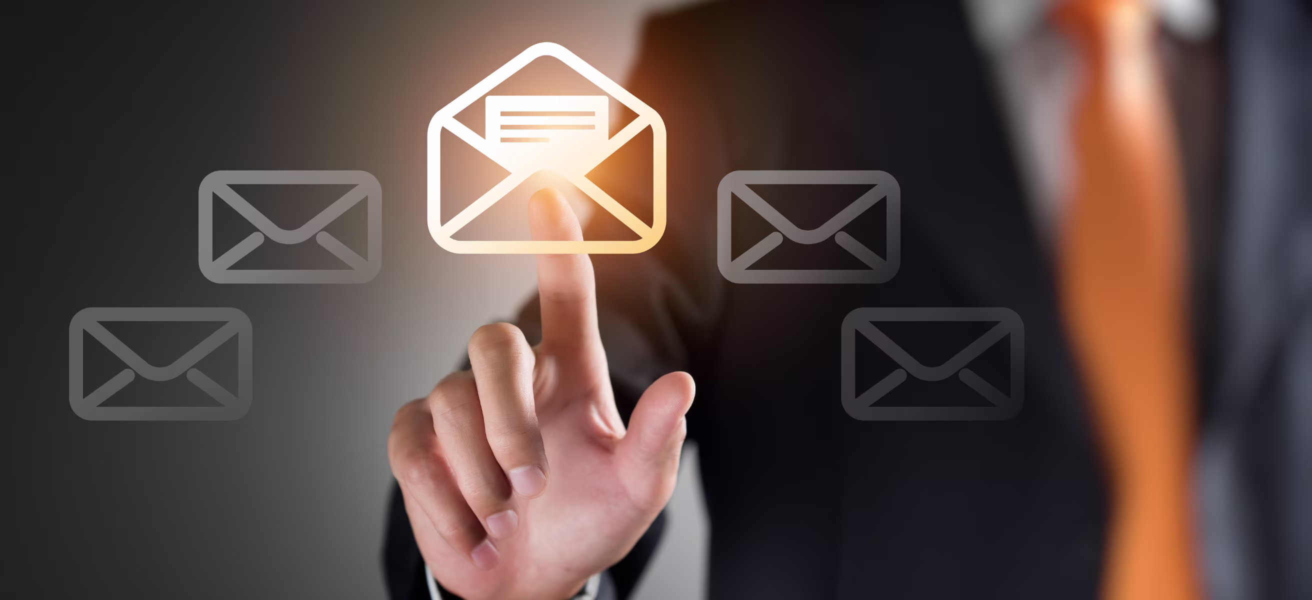 Businessman touching email icon on virtual screen; concept of email marketing and B2B communication automation