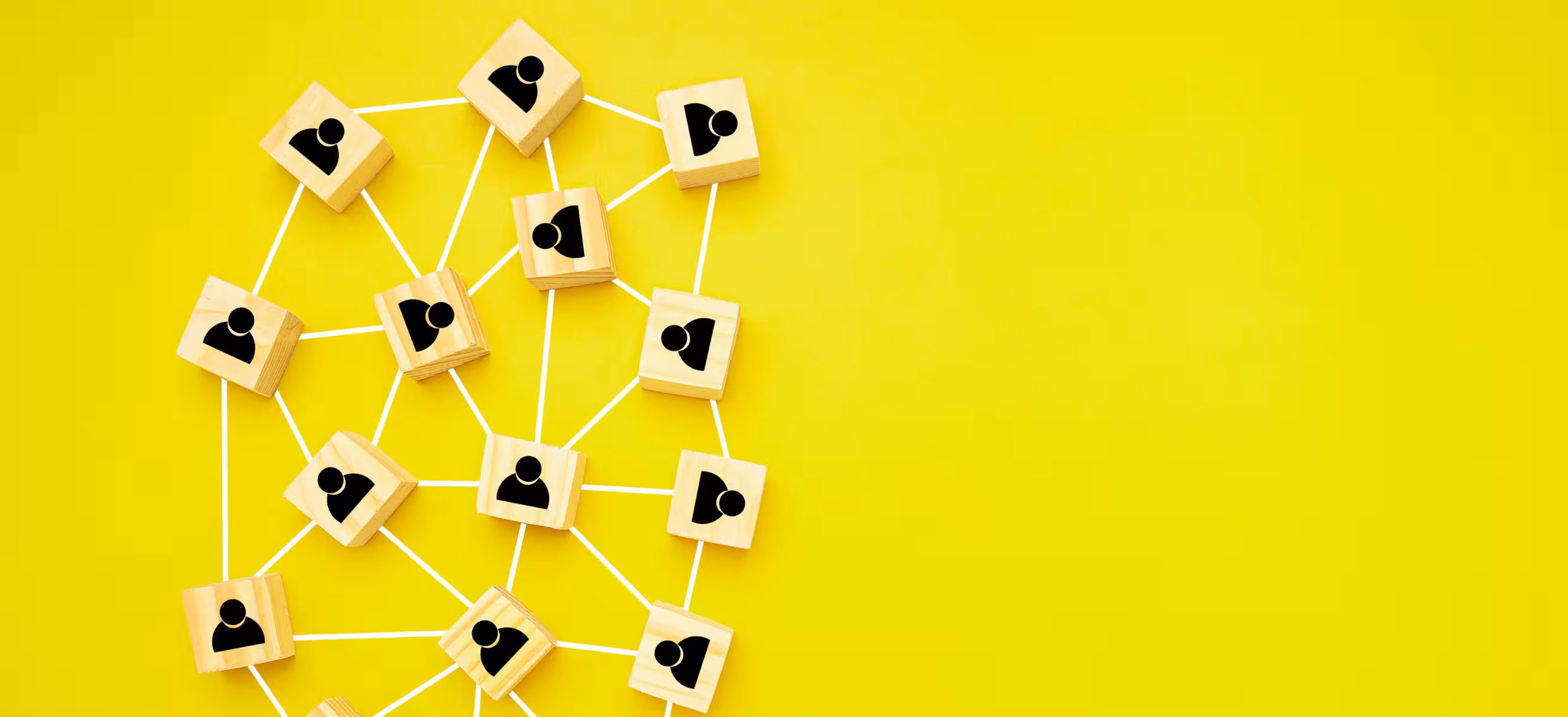 A vibrant yellow wall adorned with a collection of wooden blocks in different shapes and sizes.