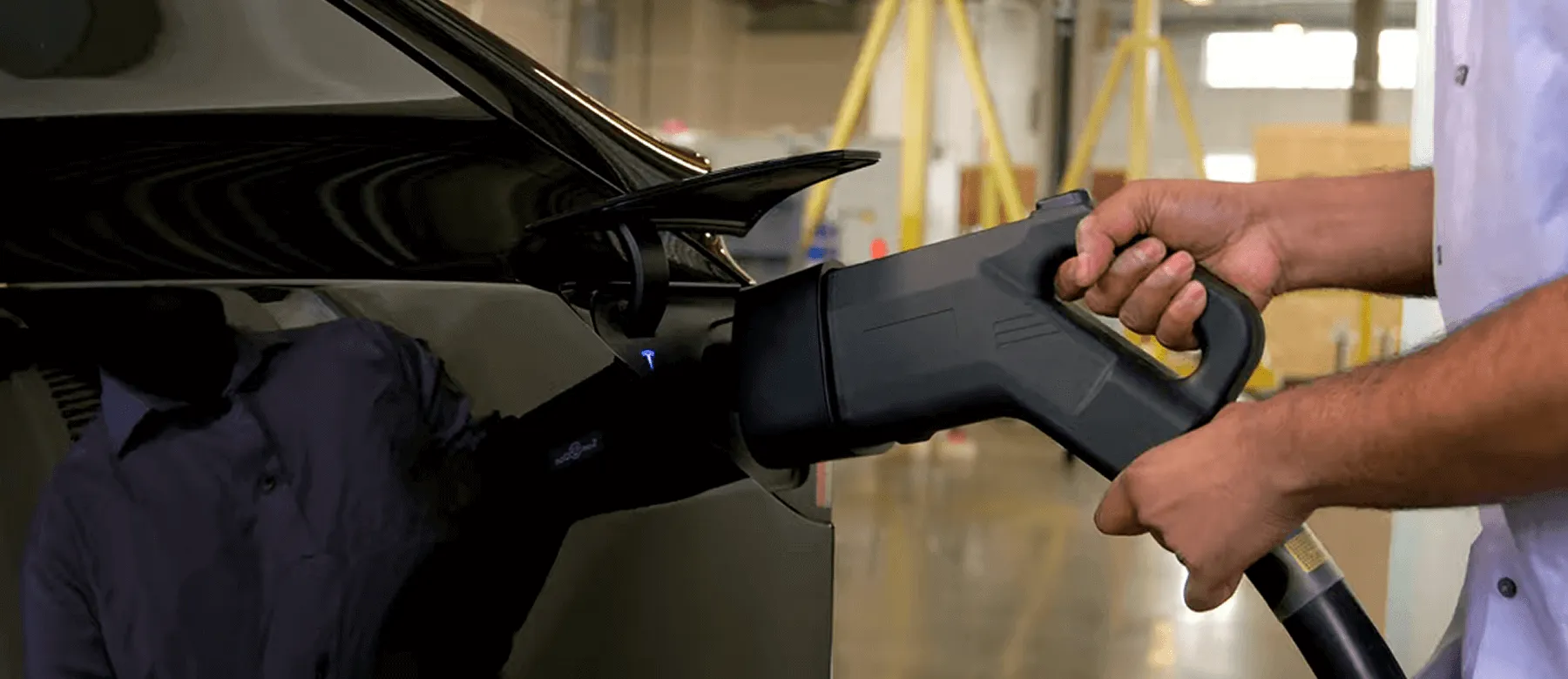Driver is connecting the Electric Era's charging port to an EV