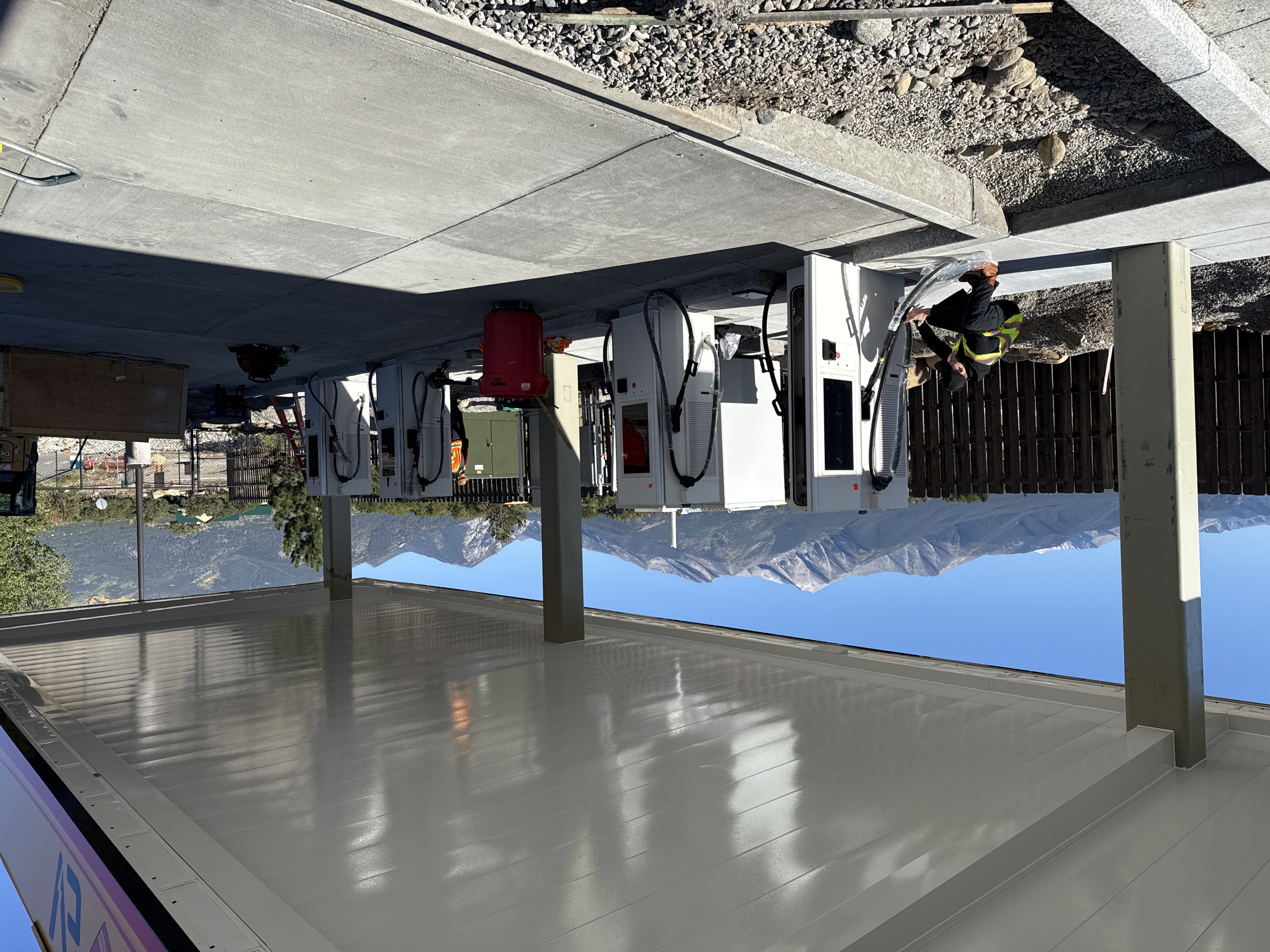 Completed charging stalls during commissioning, with mountains in the background