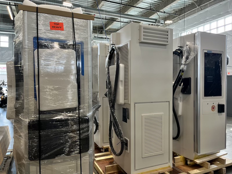 Fast charging units staged under the canopy, still wrapped after delivery