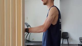 Physio démontrant rotation externe isométrique de l'épaule