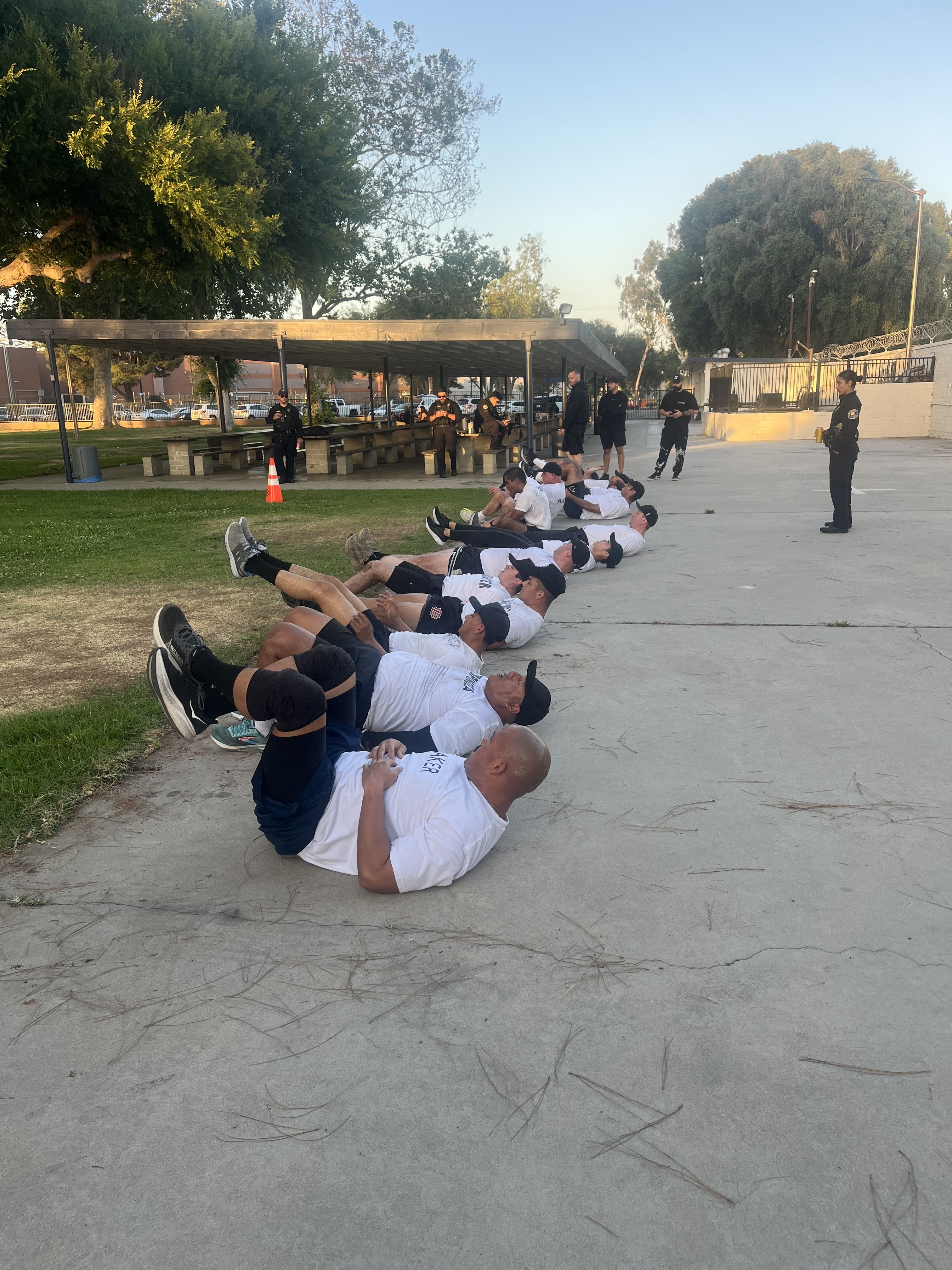S2 recruits performing a sit-up drill at an academy facility at sunrise