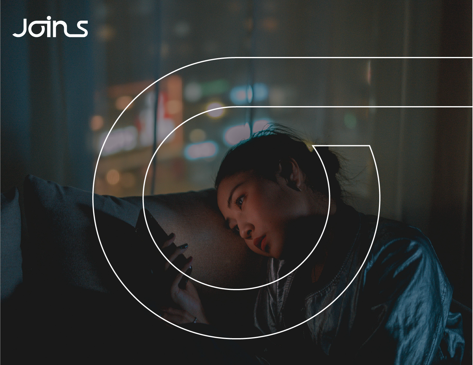 Boy on his phone with the Joins logo