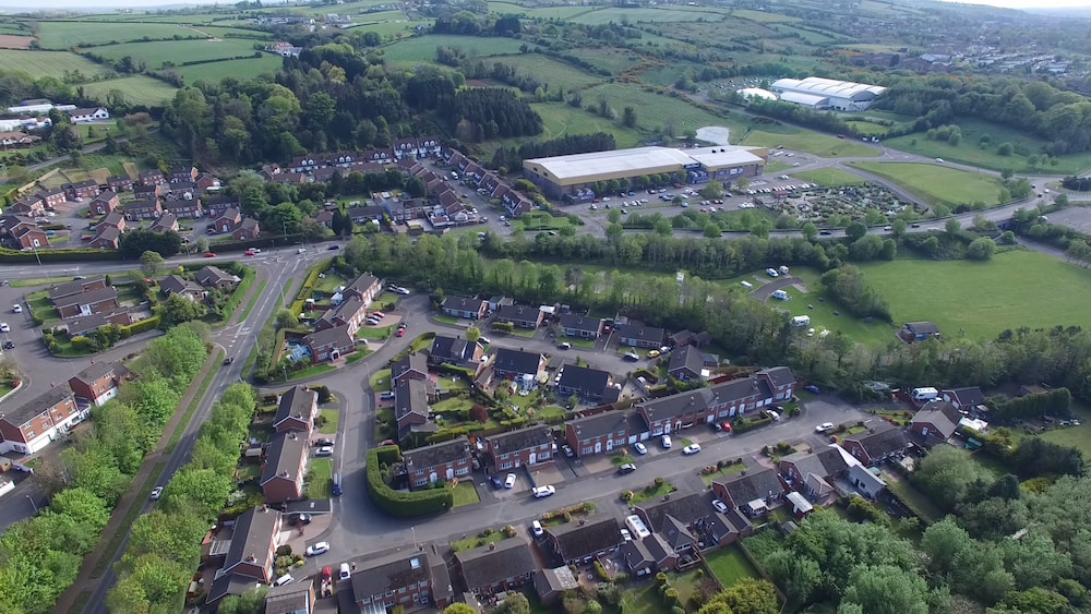 View over Dundonald, showing residential neighborhoods, local shopping areas, parks, and the Dundonald Ice Bowl entertainment complex.
