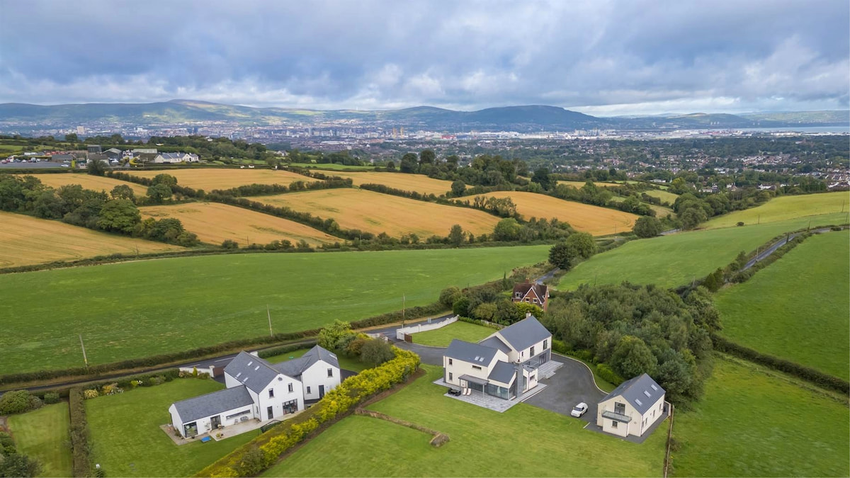 Aerial view of Gilnahirk, featuring suburban homes surrounded by trees and green areas.