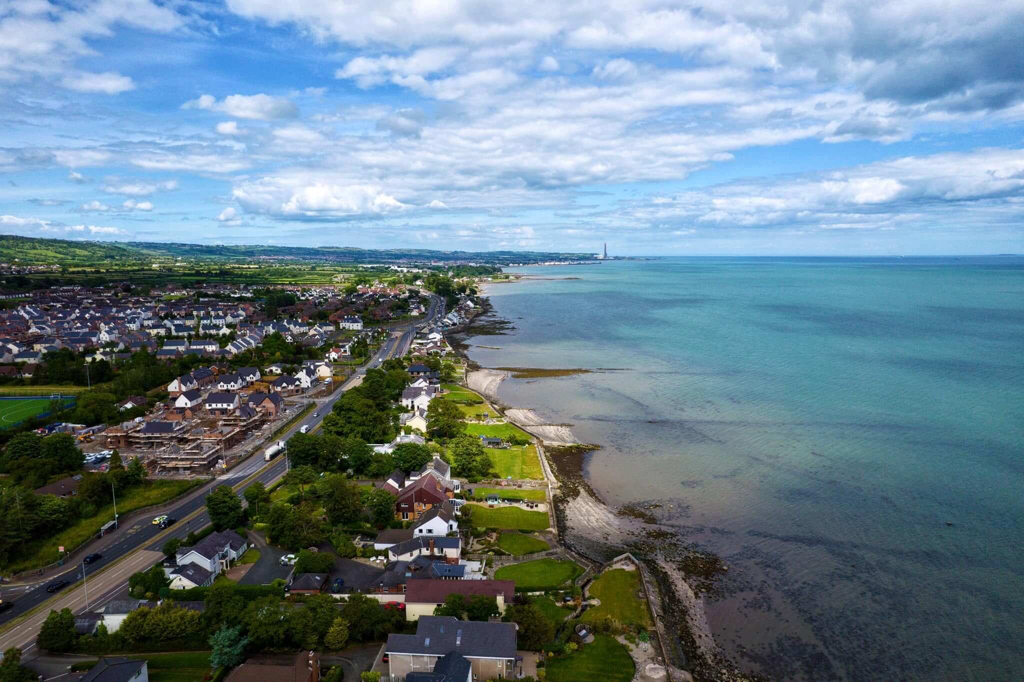 View over Whiteabbey, showing homes and the Belfast Lough shoreline.