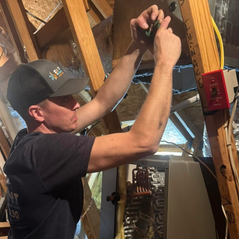 HVAC technician working on attic