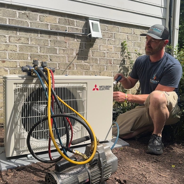 Greg Thomas working on heat pump