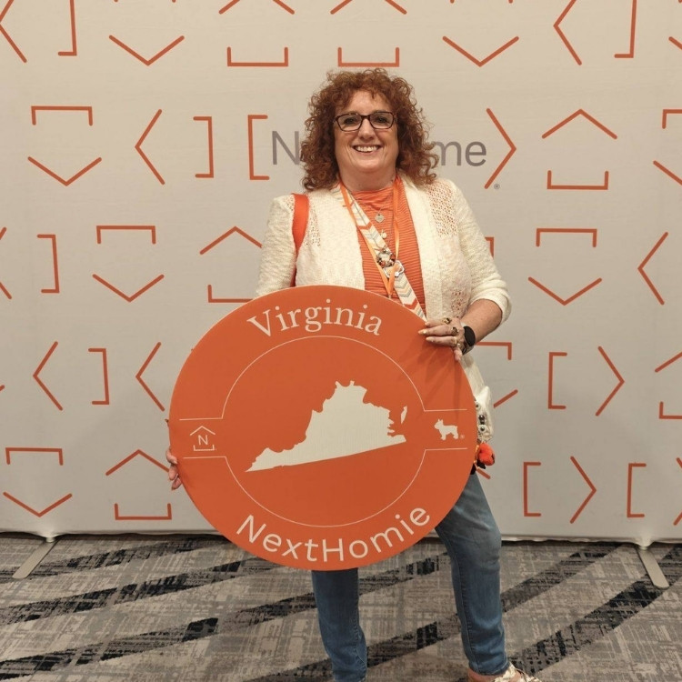 Janet Nowlin holding sign that says "Virginia NextHomie"
