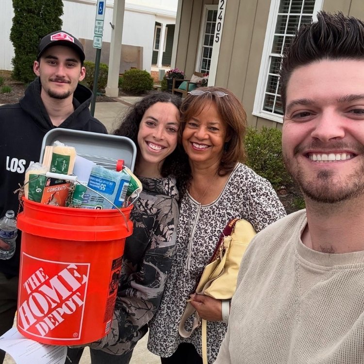 Cody Adams with new buyers and Home Depot bucket gift