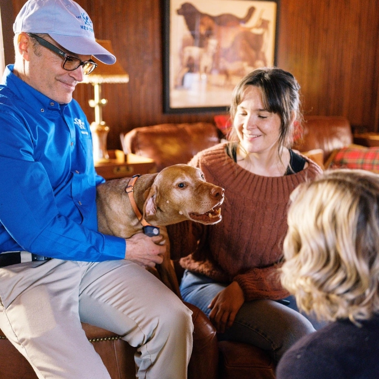 Tim Mullins with dog in family room
