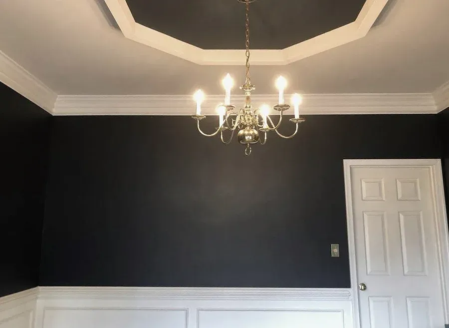 Black wall dining room with white trim