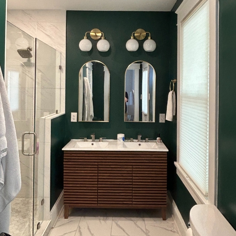 Bathroom with green wall and dual vanity