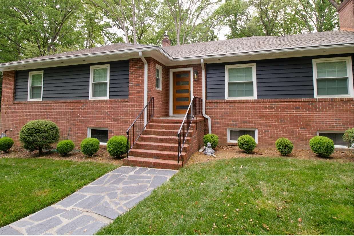 Brick house with dark wood features, ranch style home