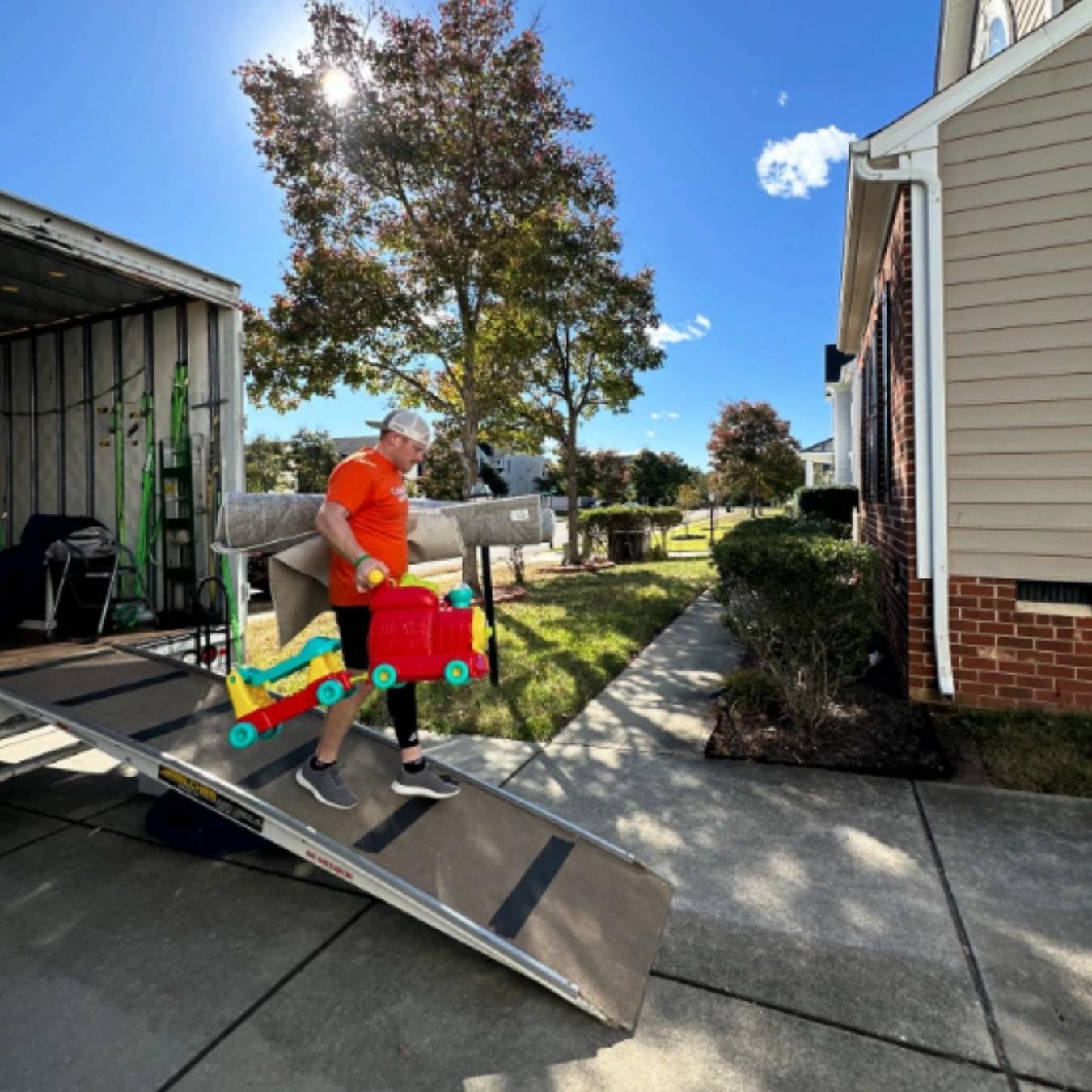 Mover man on truck ramp carrying stuff