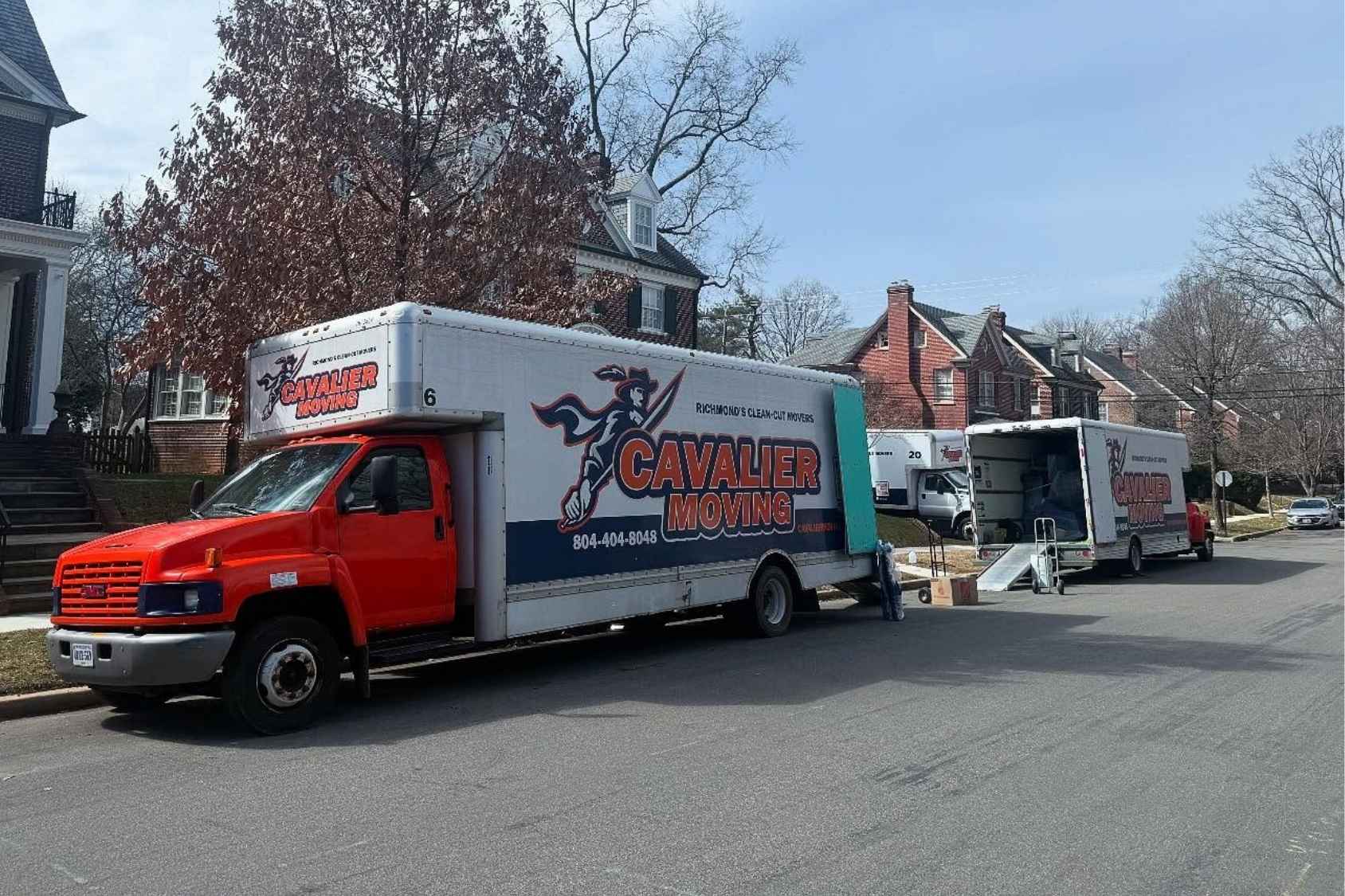 Box truck with men moving furniture on ramp