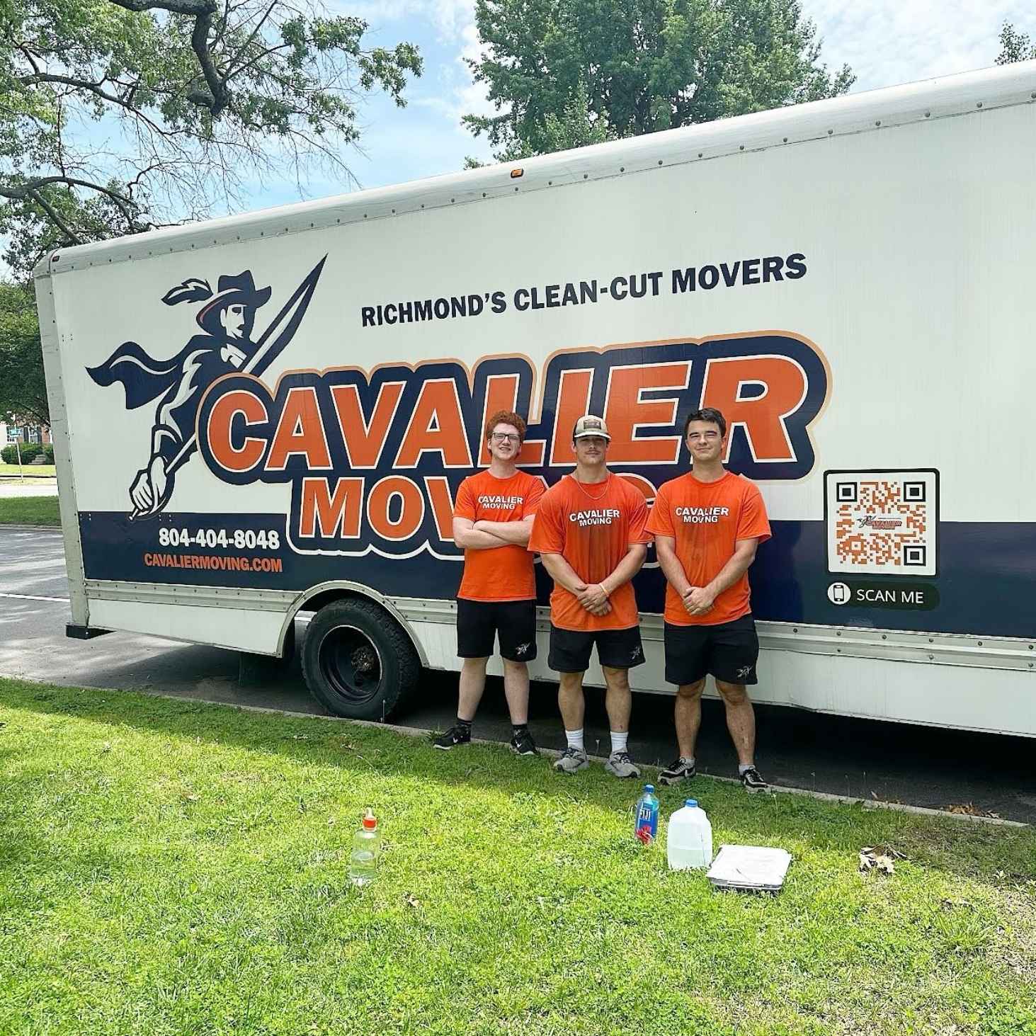 3 movers standing in front of Cavalier moving truck