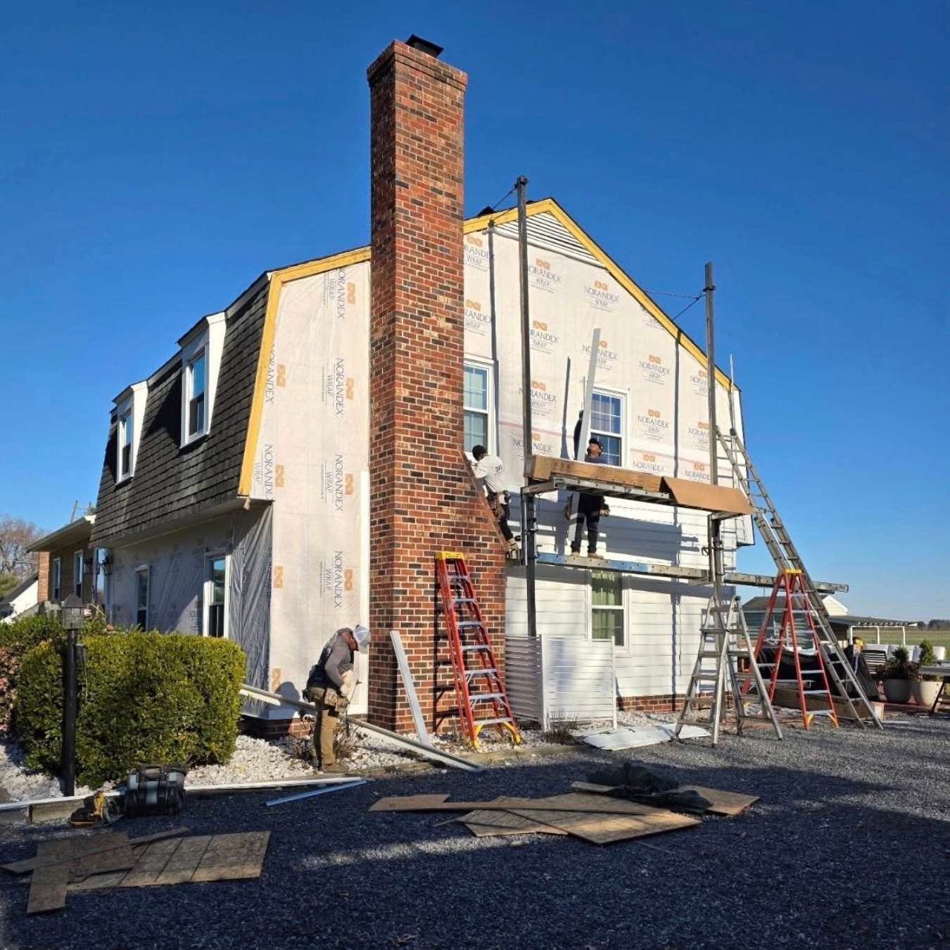 construction on side of home with brick fireplace chimney