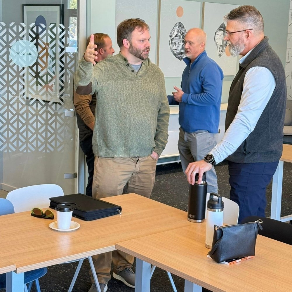 2 men having a conversation at a S.A.L.T. meeting