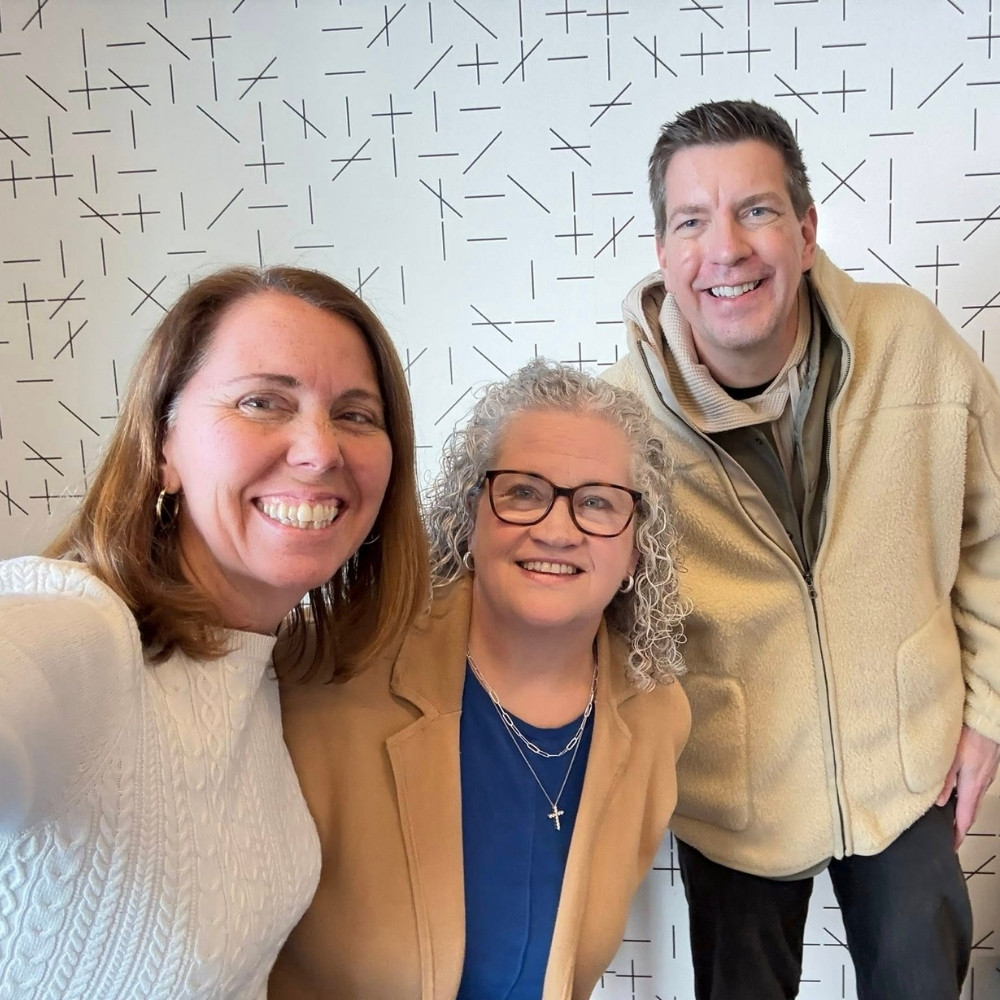 2 women and 1 man posing for a photo
