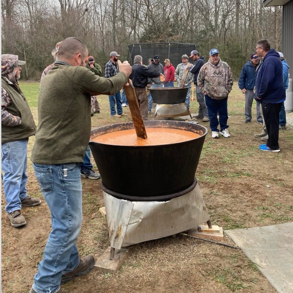 Man stirring brunswick stew
