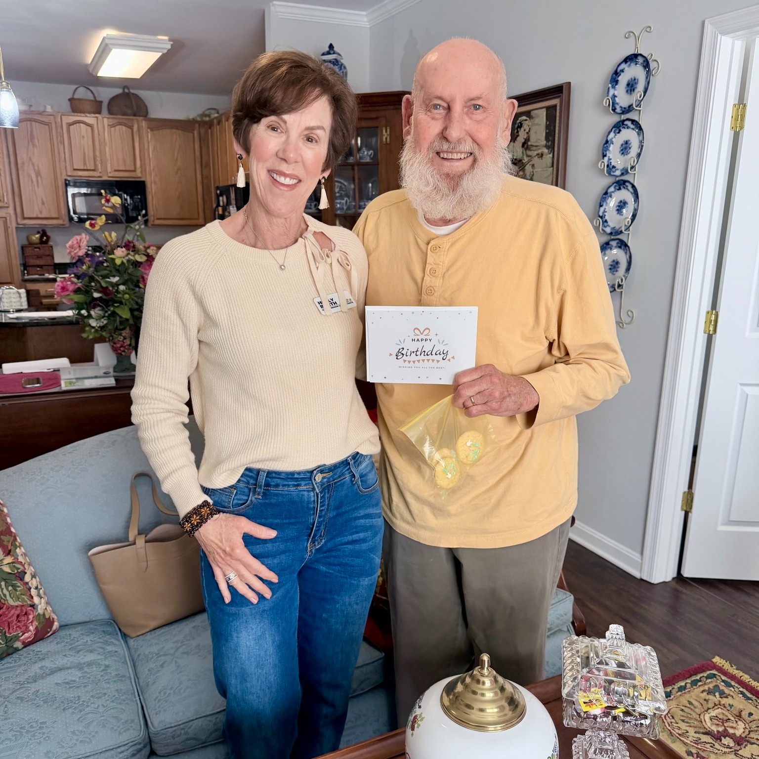 Older man standing next to younger woman