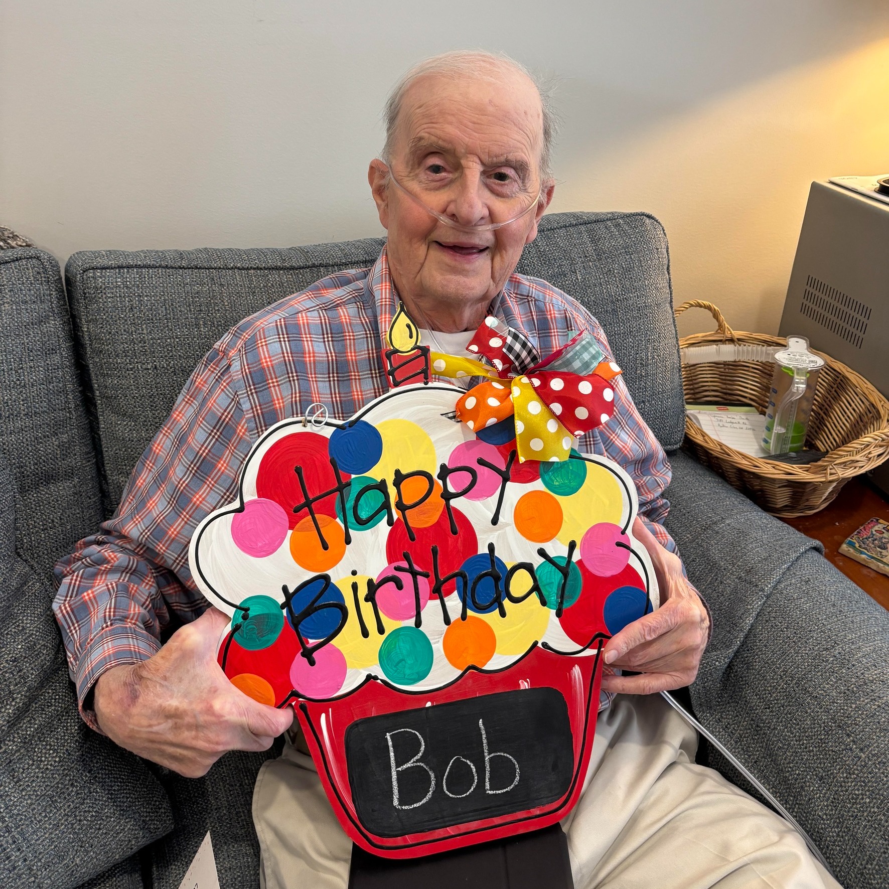 Old man with a sign that says Happy Birthday Bob