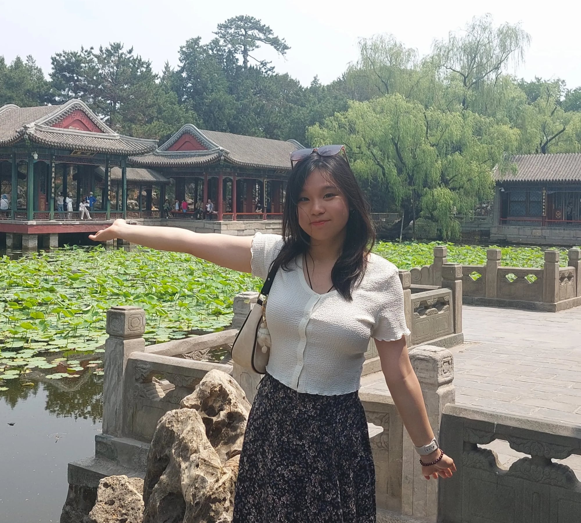 A gif of an avatar that has long black hair, red top and black and white skirt