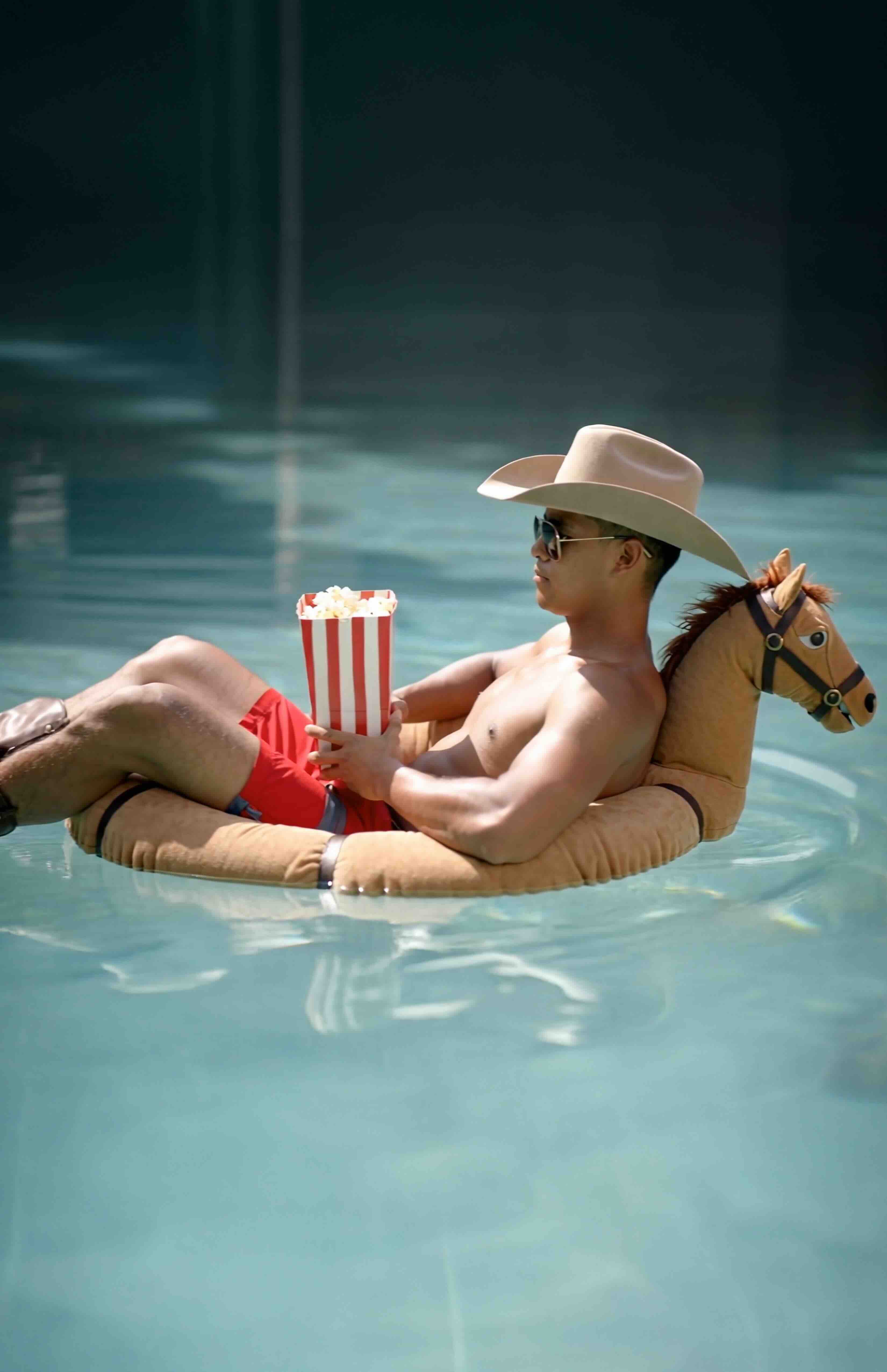 cowboy floating in pool