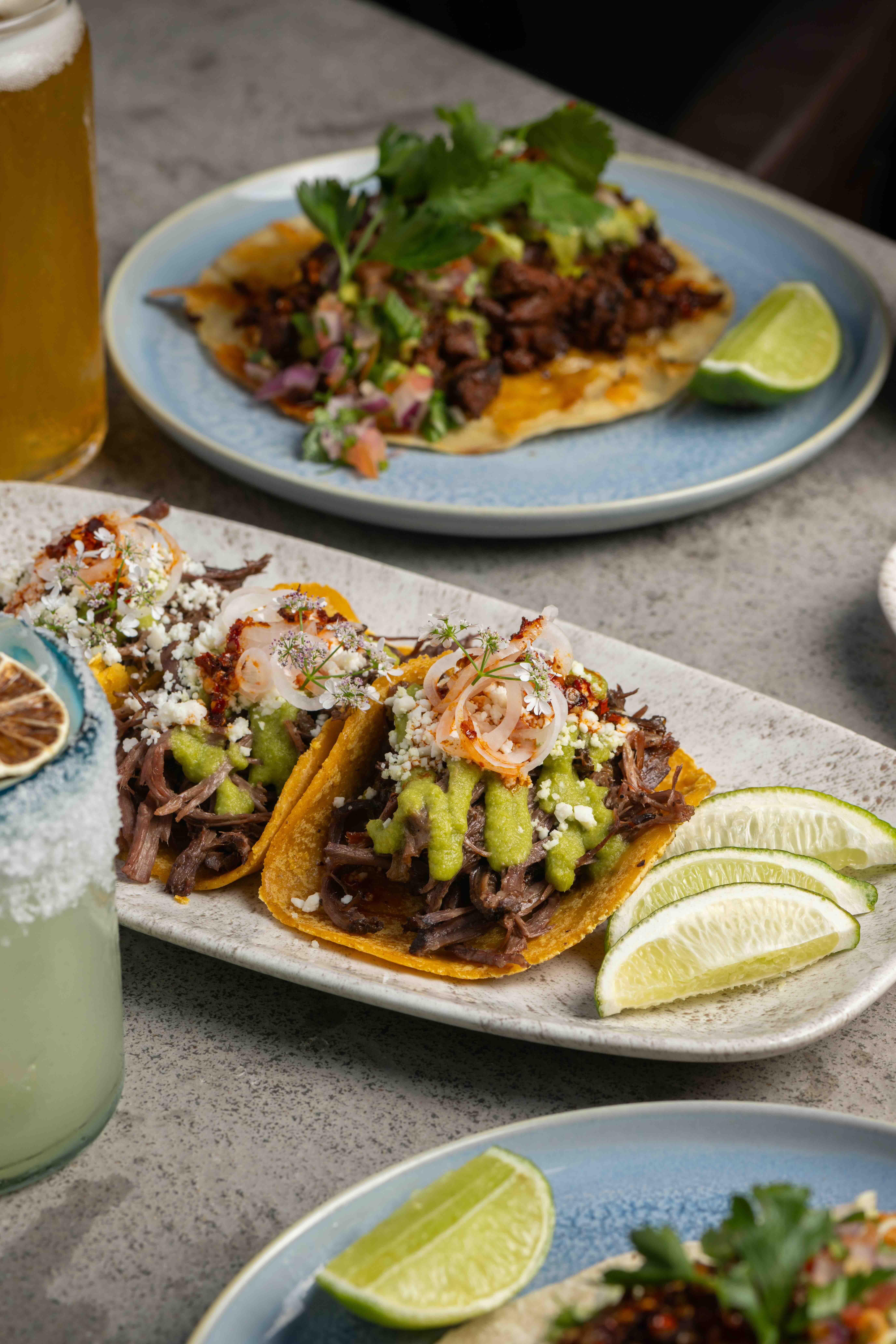 3 chicken tacos with a lime wedge