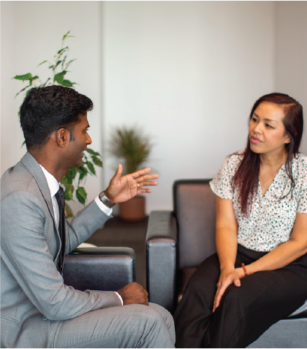 A man and women having a friendly discussion in an office setting 