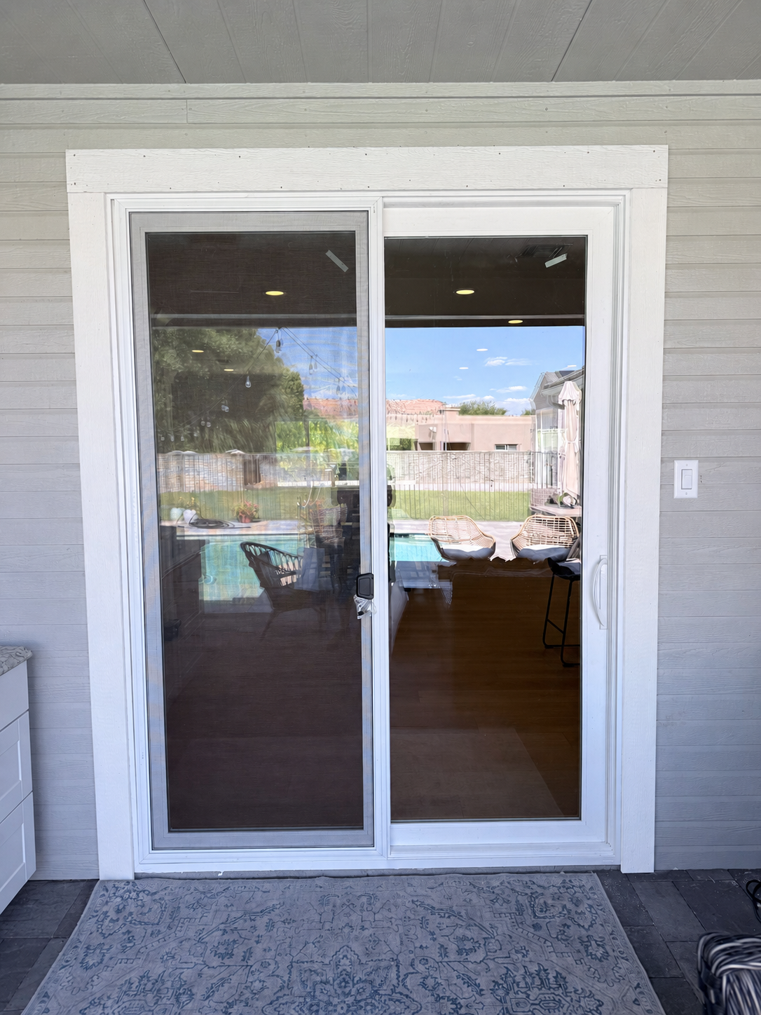 Finished exterior of 8-foot sliding glass door with white painted trim
