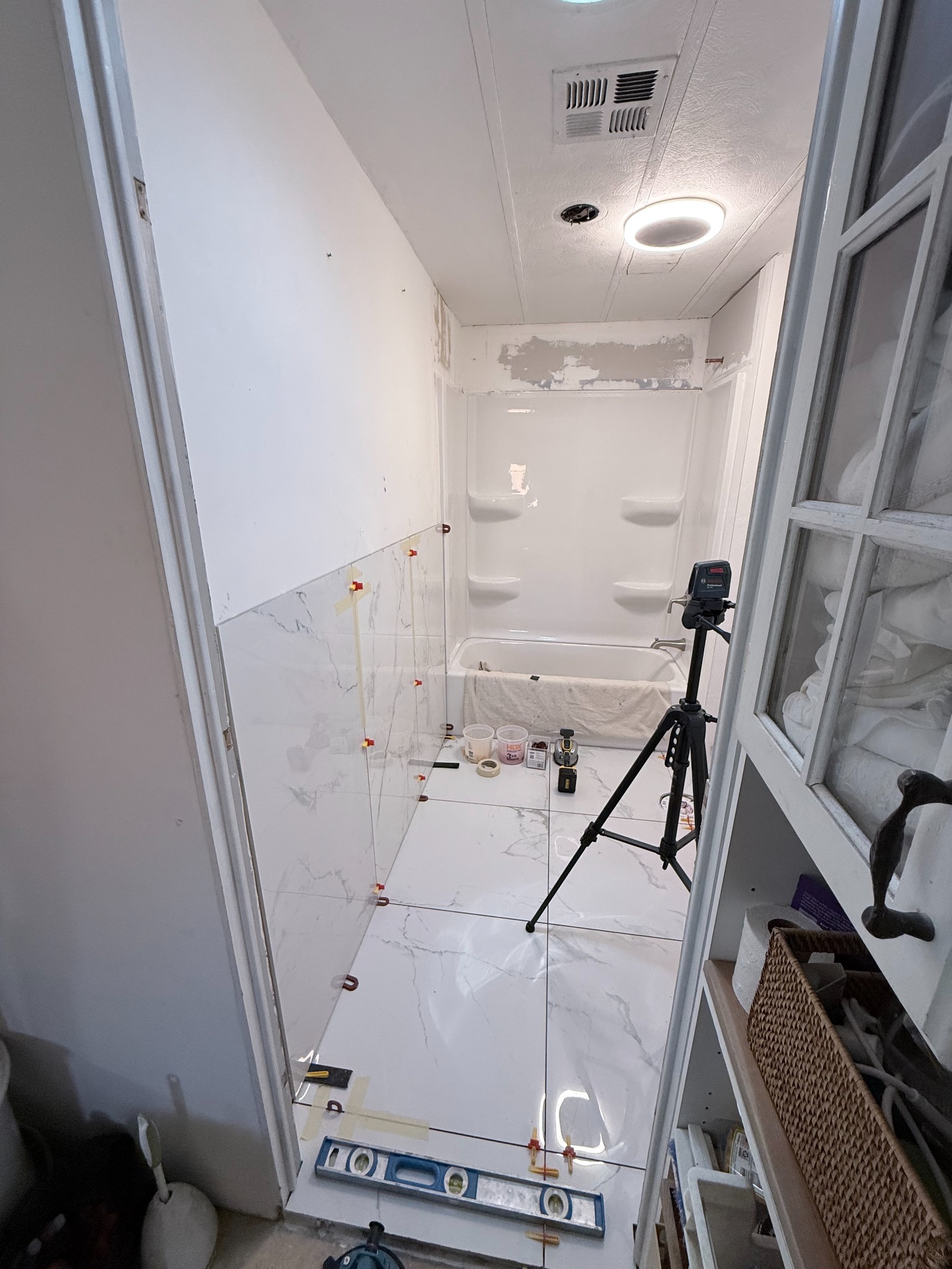 24 x 48 wall tile and 24 x 24 floor tile installation in progress