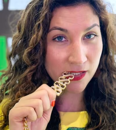 Boss Photo Wall: property manager biting a gold BOSS necklace