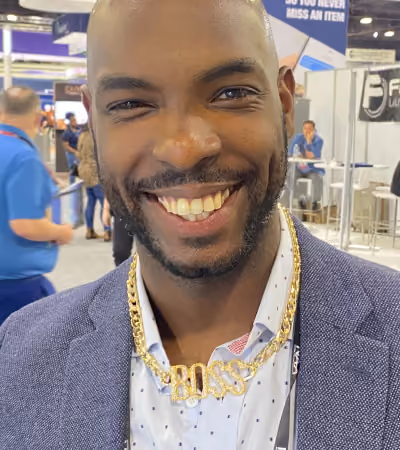 Boss Photo Wall: trade show attendee wearing a gold BOSS chain