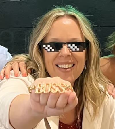 Boss Photo Wall: property manager in pixel sunglasses showing a BOSS necklace