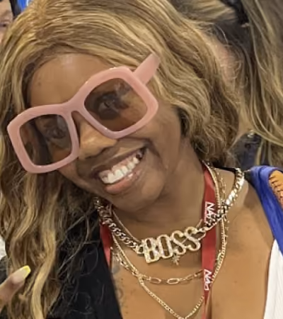 Boss Photo Wall: attendee in pink sunglasses and a gold BOSS necklace