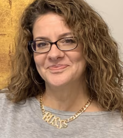 Boss Photo Wall: property manager smiling in a gold BOSS necklace