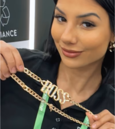 Boss Photo Wall: property manager holding up a gold BOSS necklace