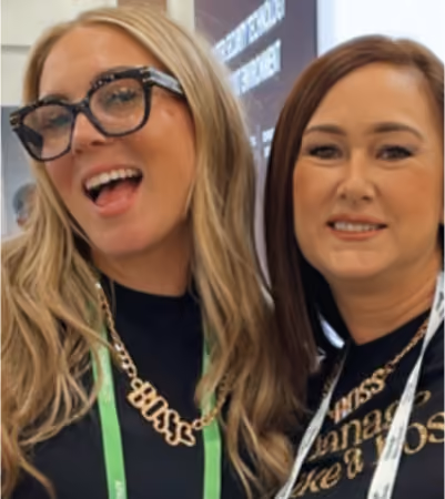 Boss Photo Wall: two conference attendees in gold BOSS necklaces