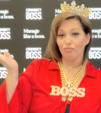 Boss Photo Wall: property manager in a crown and gold BOSS necklace at the Community Boss booth