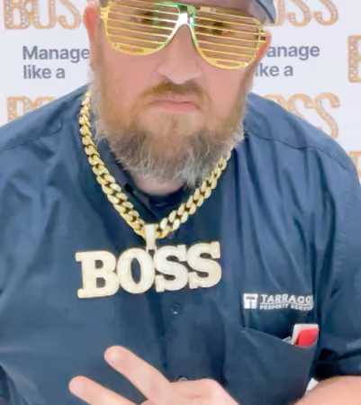Boss Photo Wall: property manager in party glasses and a gold BOSS chain at the Community Boss booth