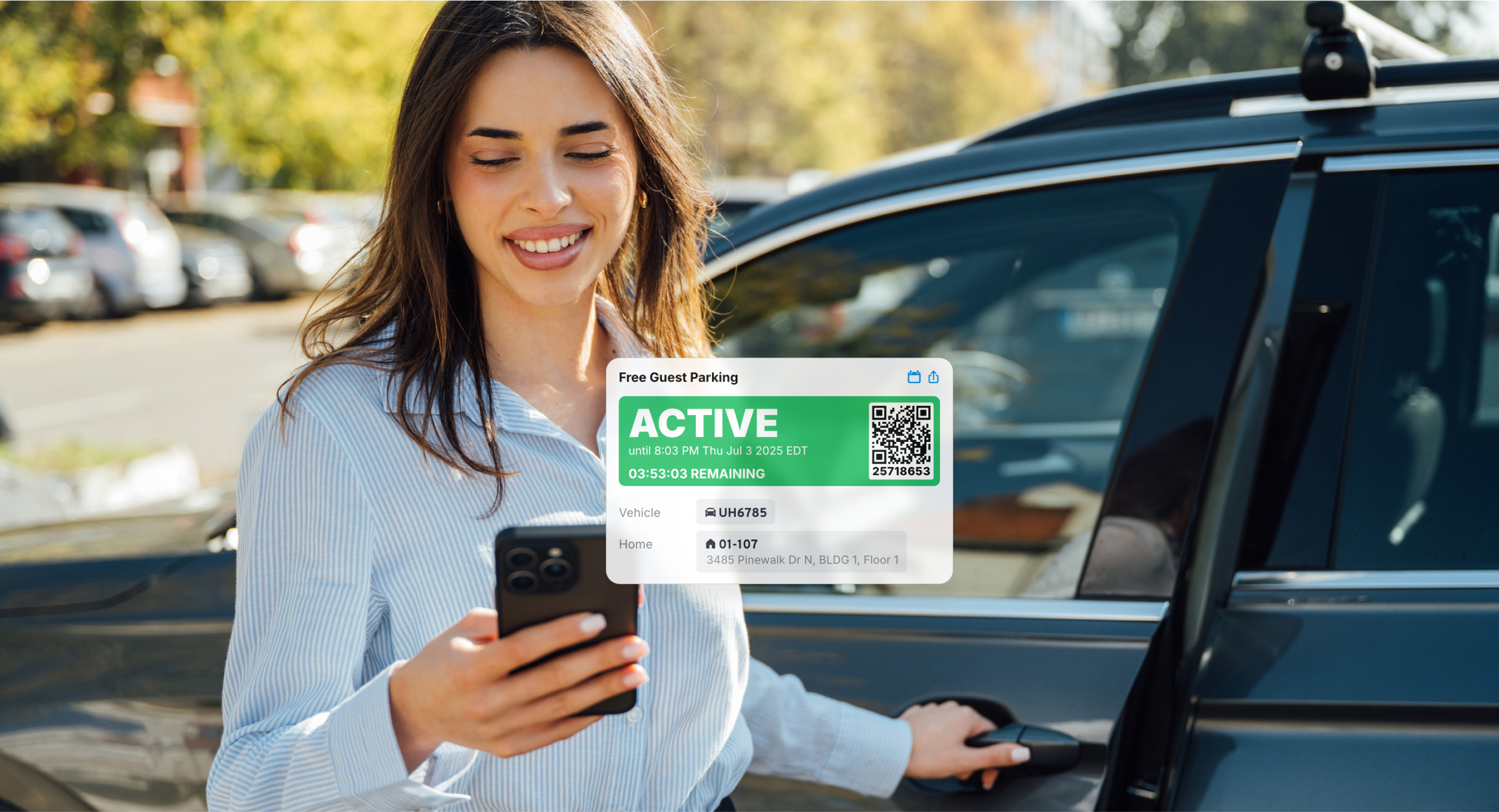 Resident at her car holding a phone with an active free guest parking pass