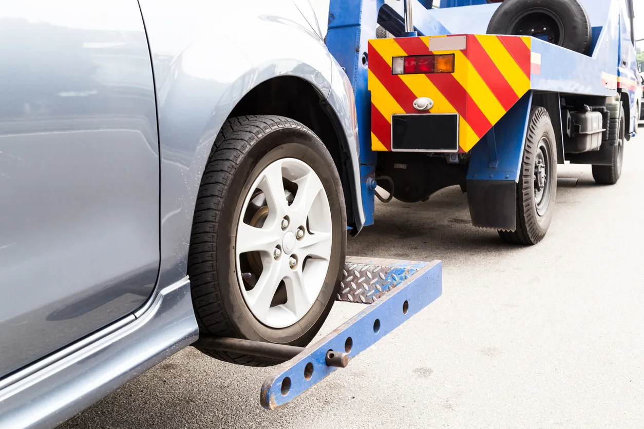 Tow truck lifting a parked car