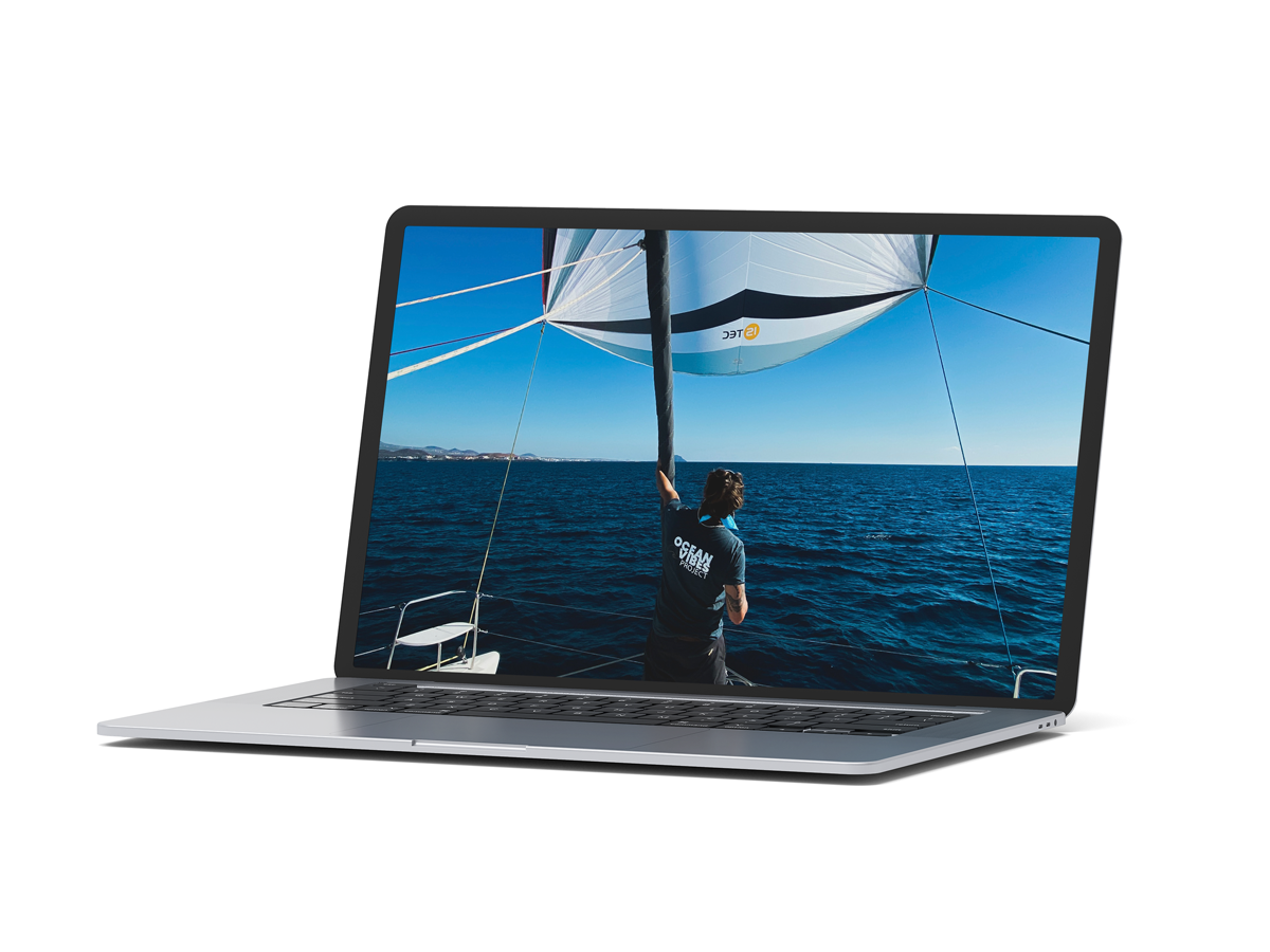 a mockup of a mac book that shows a sailor standing on the foredeck of his sailing catamaran