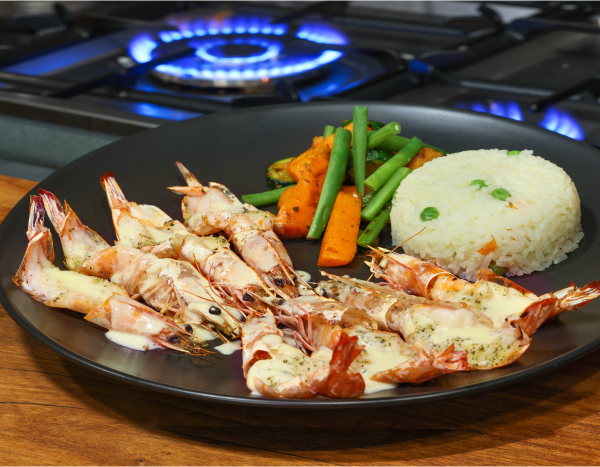 a plate of parwns and rice on a stove