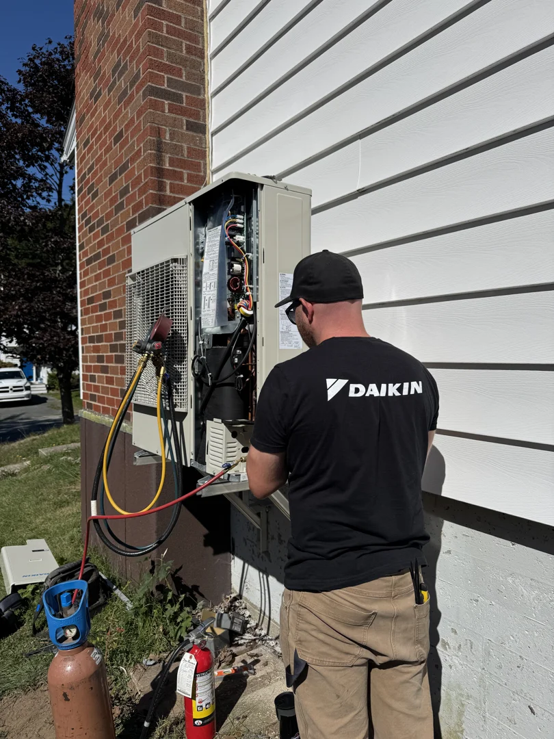 Technician using digital diagnostic tools to calibrate a Daikin unit - how daikin certification ensures quality installation