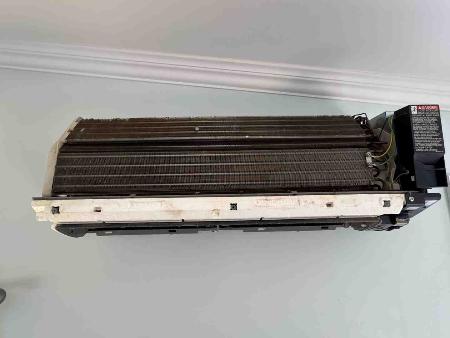 A close-up of an evaporator coil with frost beginning to form, showing the heat exchange process - heat pump performance in A close-up of an evaporator coil with frost beginning to form, showing the heat exchange process - heat pump performance in