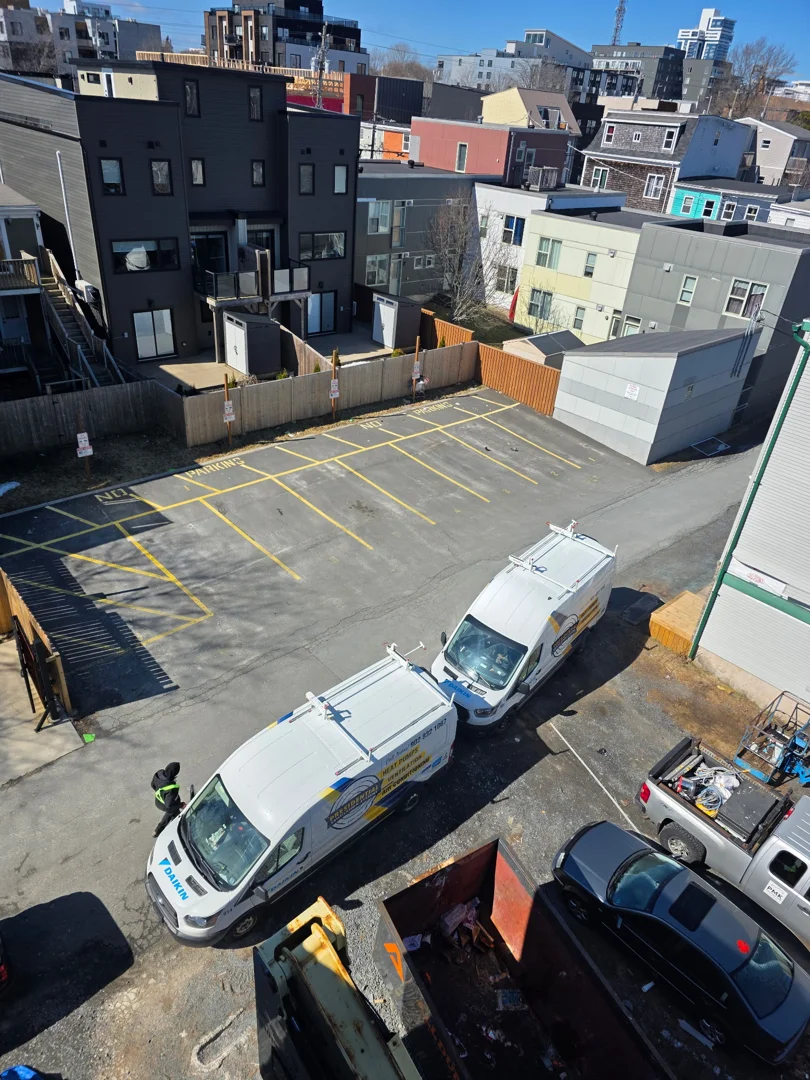 Modern apartment building parking lot equipped with multiple Level 2 EV charging stations Modern apartment building parking lot equipped with multiple Level 2 EV charging stations